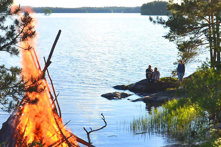 Juhannusjuhla Juhannusjuhlaa leirikeskuksessa, rannalla juhannuskokko
